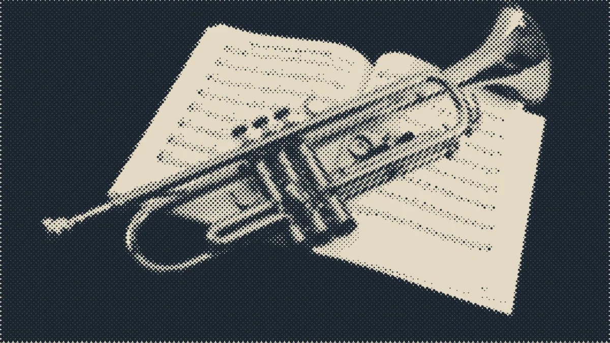 A trumpet on a dark table.