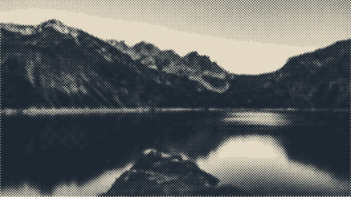 An alpine lake below mountains.