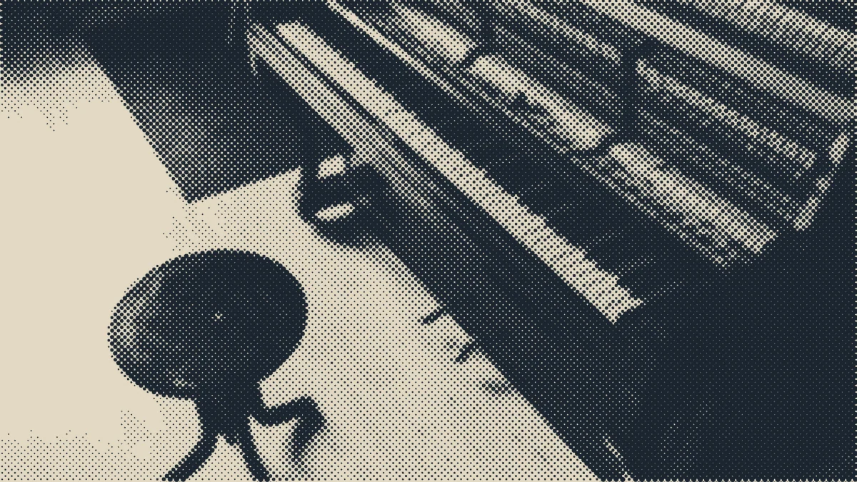 An empty practice room with an upright piano.